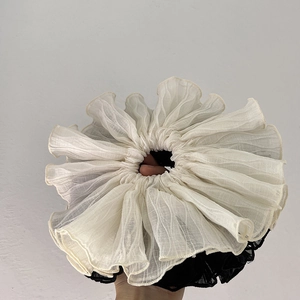Detail of white and black layered oversized hair scrunchie with pleated organza texture