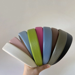 Detail view of multi-color wide chunky faux leather headbands in various elegant shades