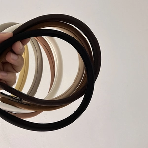 Detailed view of handmade fabric headbands showing high-quality twill texture and labels