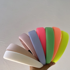 Detailed close-up of colorful padded headbands showing textured fabric in eight vibrant colors