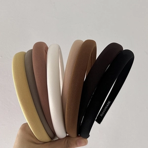 Close-up of handmade cloth headbands showing fine ribbed texture and varied solid colors