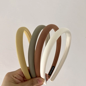 Detail of padded twill fabric headbands with handmade label in four vintage colors