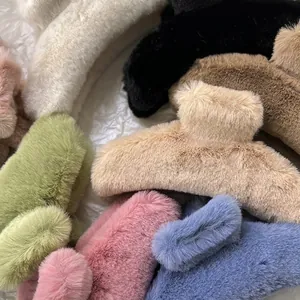 Furry plush hair claw clips in various colors for thick hair styled on white fabric