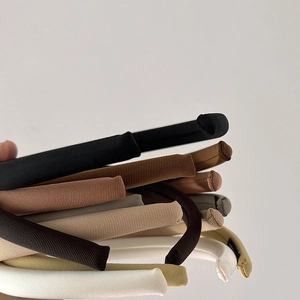 Close-up of ribbed fabric headbands in various earthy tones showing texture and detail