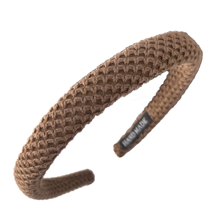 Brown knitted waffle texture headband with handmade label for elegant autumn style