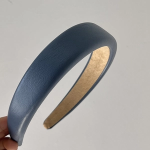 Detail of greyish blue faux leather headband with litchi texture and thick sponge padding