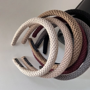 Detailed view of knitted headbands with handmade labels in diverse Morandi colors