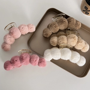 Large plush claw clip set with five soft faux fur balls in various neutral colors