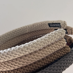 Close-up of waffle-knit fabric texture and handmade label on stylish headbands