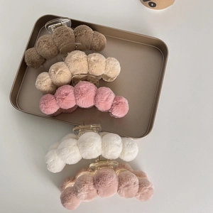 Set of 5 plush faux fur hair claw clips in autumn colors on a metallic display tray