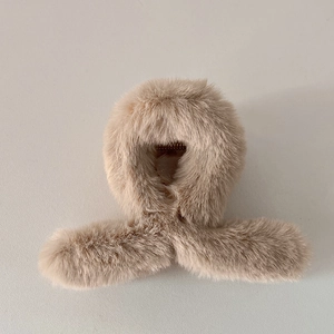Gros plan détaillé d'une pince à cheveux en fausse fourrure kaki avec un ressort métallique sûr