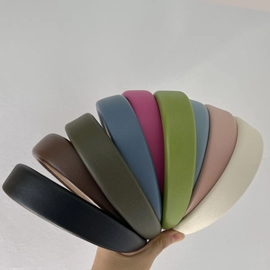 Close-up of colorful thick padded headbands with leather texture in nine vibrant colors