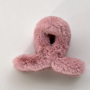 Détail de la pince à cheveux en peluche rose avec texture douce et aspect fausse fourrure