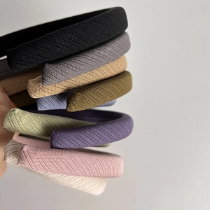 Close-up of assorted colorful twill sponge headbands showing textured fabric and rich colors
