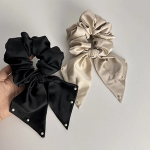 Elegant satin bow scrunchie with pearl detail and long streamers in black and champagne
