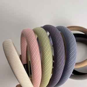Close-up of handmade ribbed fabric sponge headbands in various pastel colors