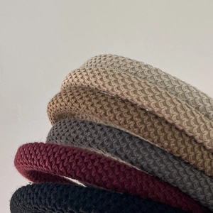 Close-up of knit headbands with waffle texture in cream, khaki, grey, red, and black