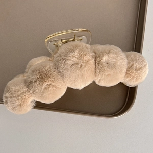 Detailed macro view of soft plush faux fur claw clip with transparent plastic base