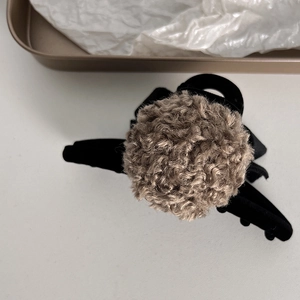 Detail of plush brown faux fur claw clip with soft texture for autumn winter styling