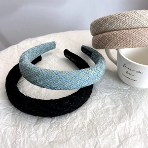Detail showing various colors of woven tweed headbands with handmade interior labels