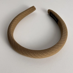 Detailed view of the handmade label on khaki twill fabric sponge headband
