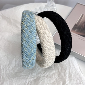 Three padded tweed headbands in blue, beige, and black for a high top hair look