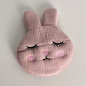 Close-up of pink corduroy rabbit hair clip featuring detailed embroidery and soft texture