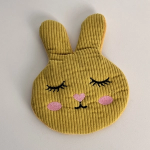 Close-up of mustard yellow corduroy rabbit hair clip with detailed embroidery and pink heart