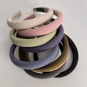 Minimalist fabric sponge headband in various solid colors with ribbed texture