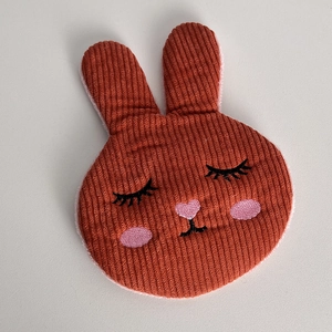 Detail of red-brown corduroy bunny hair clip with cute embroidered face features