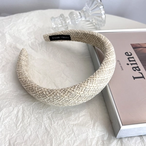 Detail of tweed weave headband texture with hand made label on stylish magazine background
