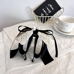 Elegant banana hair clip with lace bow and pearl accent for high ponytail styling