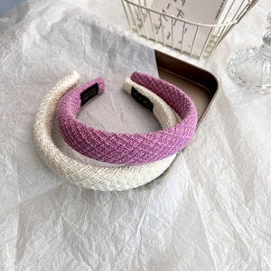 Close-up of pink and purple tweed headbands with gold metallic thread and handmade label