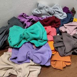 Detailed close-up showing various colors of ribbed knit bow headbands for women