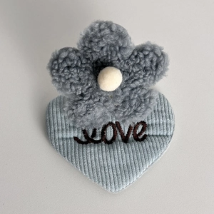Detail view of heart plush hair clip with light blue corduroy and Love embroidery