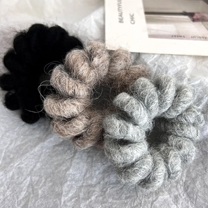 Three-piece wool telephone wire hair ties in black, grey, and khaki on a white background