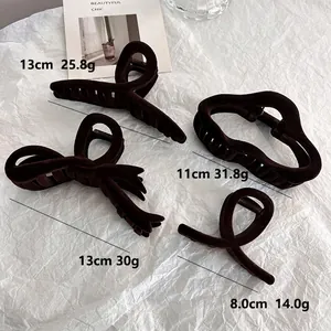 Brown flocked hair claw clips set in four styles including bow and heart shapes