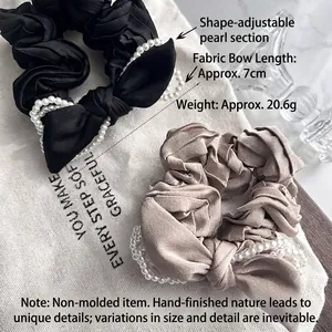 Elegant satin bow scrunchies in black and champagne with adjustable pearl trim design