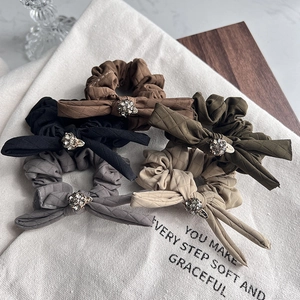 Quilted bow scrunchies with rhinestones in brown, black, green, grey, and beige