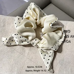 Polka dot satin silk scrunchie with rabbit ear bow design for elegant hairstyles