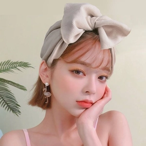 Knitted beige wide headband with oversized bow for women in winter autumn style