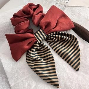Elegant striped ribbon bow scrunchie in burgundy satin with black and gold patterns