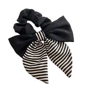 Elegant black satin bow scrunchie with striped ribbon tails for stylish hair styling