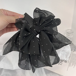 Elegant large black chiffon bow hair clip with silver studs on a layered mesh ribbon