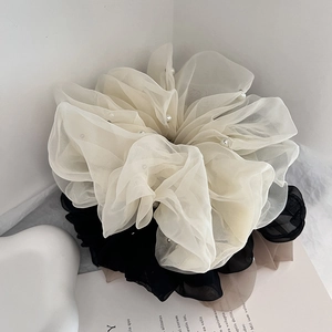 Detail of layered mesh hair scrunchies with elegant faux pearl embellishments
