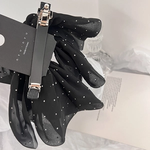 Elegant black chiffon bow hair clip with silver rhinestones on luxury card display