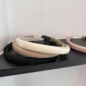 Detail of handmade satin headbands with fine jacquard texture in multiple colors