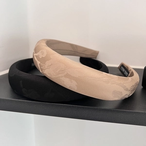 Detail view of handmade jacquard floral hairbands in black and champagne color