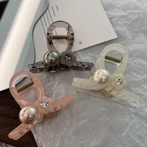 Detalle de pinza para el pelo con flor de acetato de 8 cm, perlas y pedrería en tela