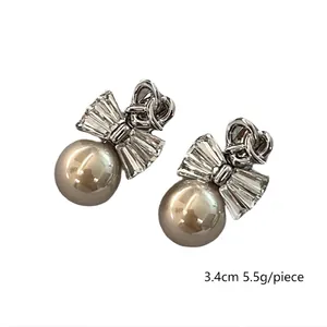 Elegant silver bow earrings with rectangular zircons and champagne pearls 3.4cm